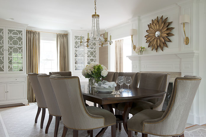 AFTER: “This is a really important room because [the clients] walk through it every day,” says Harrison of the dining room, which needs to be suitable for entertaining, but not overly formal. She chose a transitional-style long table from Hickory White with a double pedestal, and barrel-back scalloped chairs covered in a mocha velvet on the front and ribbed satin on the back. Both fabrics are from Barbara Barry.