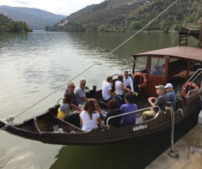 Travelers aboard a rabelo, the traditional boats used to move port wine from the vineyards to the cellars in Porto