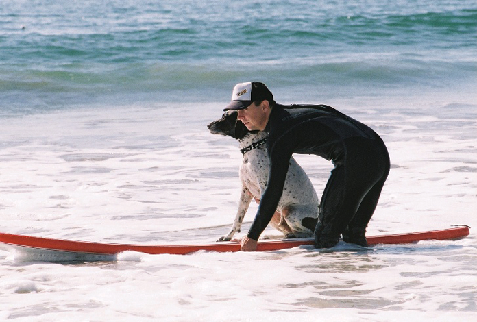 A surfing instructor and pet pupils at the Coronado Surfing Academy in San Diego, CA. Photograph by Loews Coronado Bay Resort 