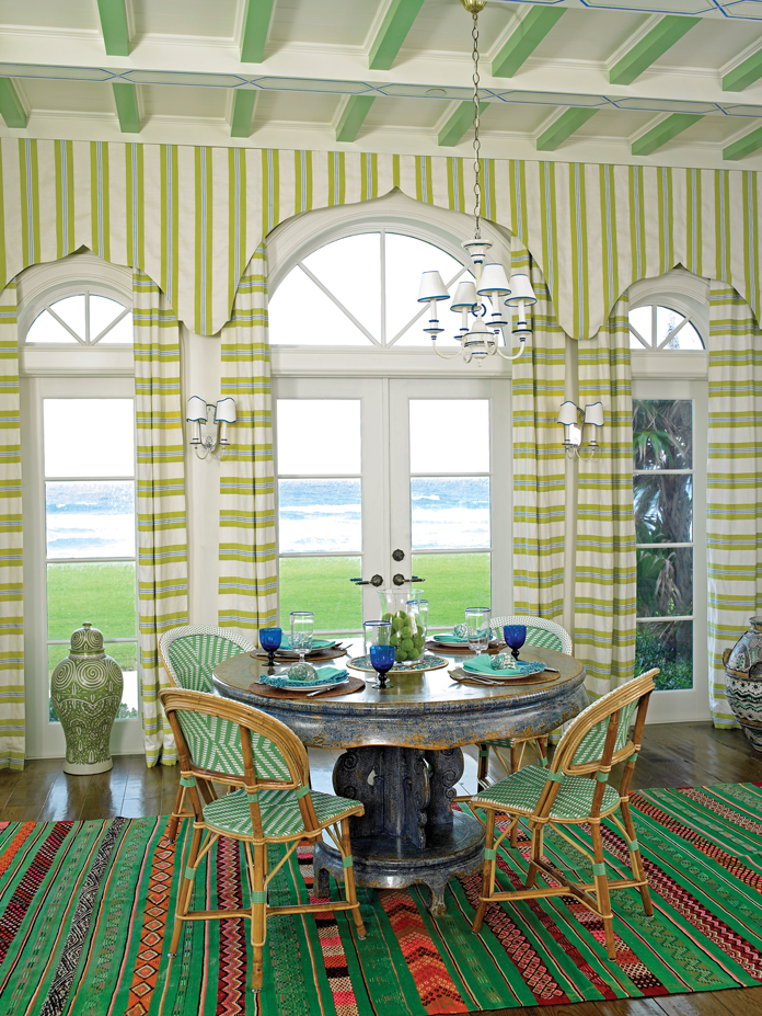 The breakfast room is grounded by a vintage green stripe carpet from Marrakech. 