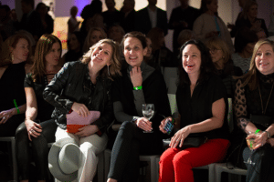 Fashion Night Out Guests sit near runway