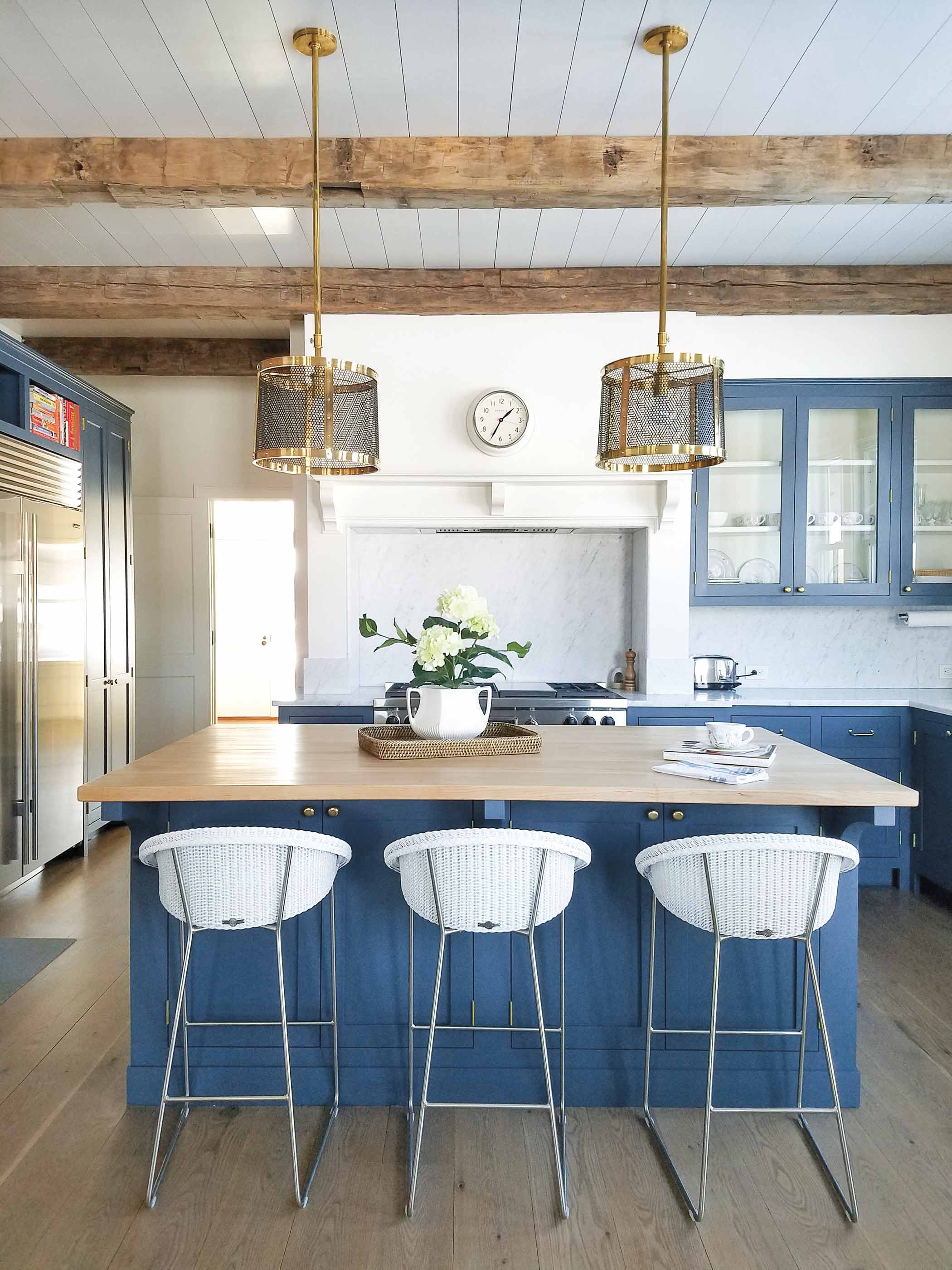 A blue island brings a pop of color to a mostly neutral kitchen 