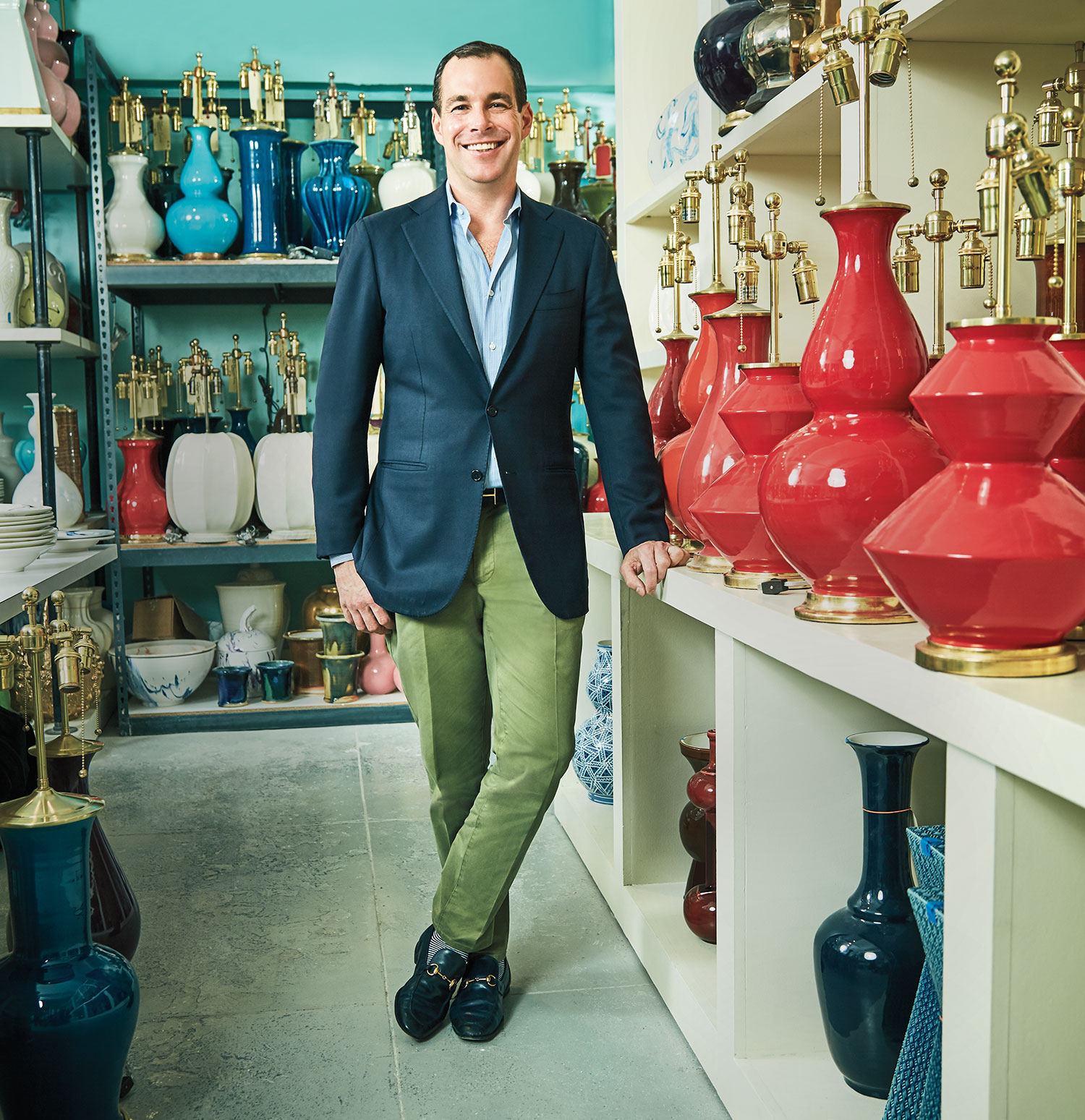 Potter Christopher Spitzmiller standing amongst the lamps he has created in his NYC studio.