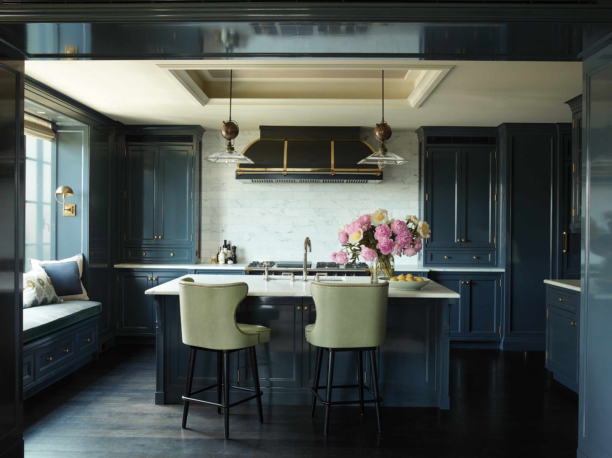 A dark blue, high gloss kitchen with white accents in a NYC apartment