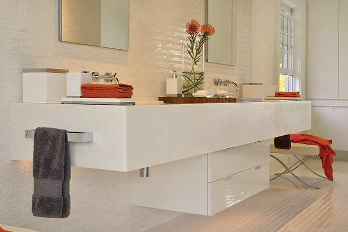 Elegance meets minimalism in this sleek bathroom suite,  featuring a custom trough sink designed by the architect.