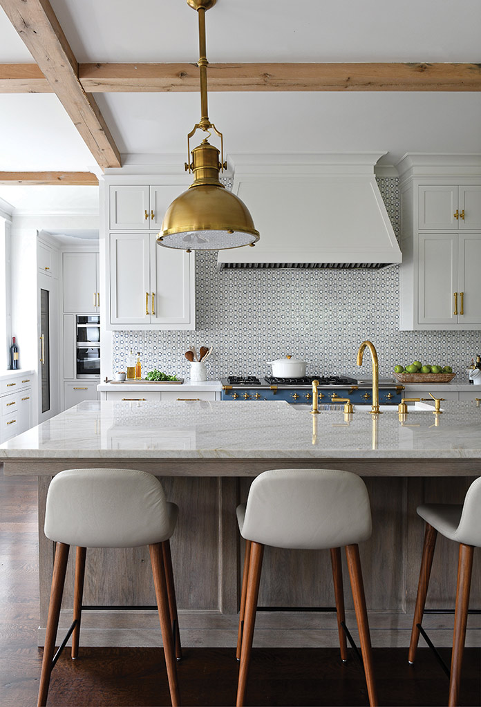 The range and backsplash tiles provide a pop of on-trend blue to this transitional kitchen.