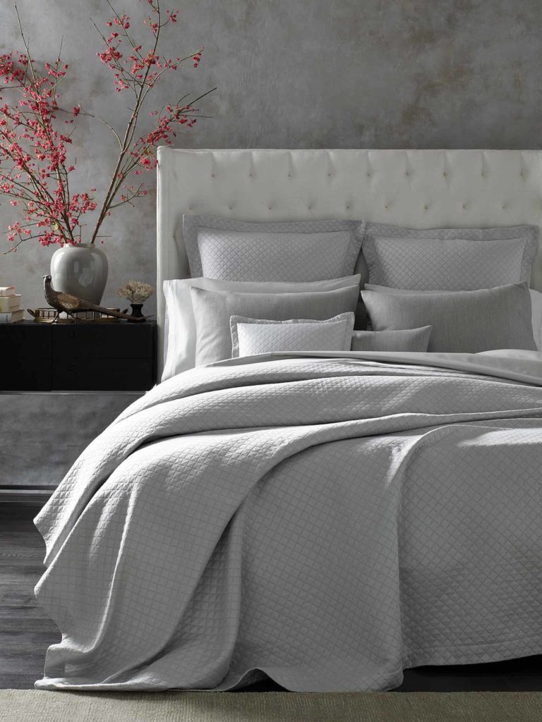 A sumptuous bed is layered with multiple textures;