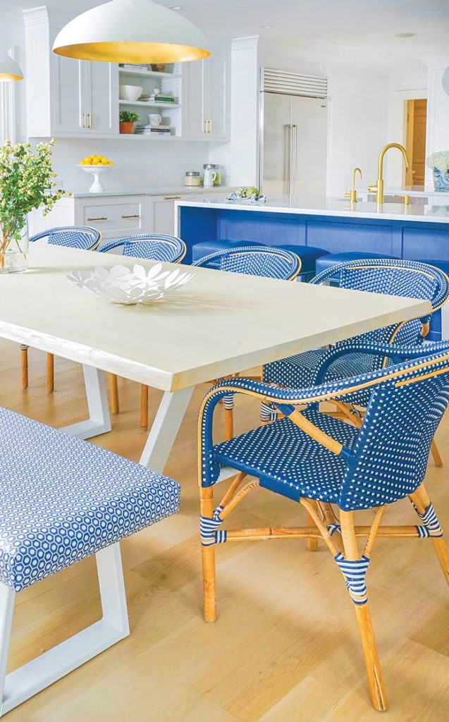 Kitchen with blue accents in chairs and bottom cabinets