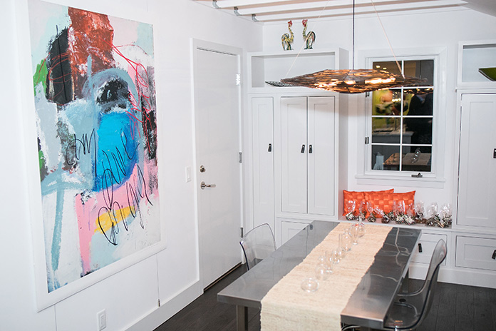 A clear kitchen table with modern artwork hung on the wall
