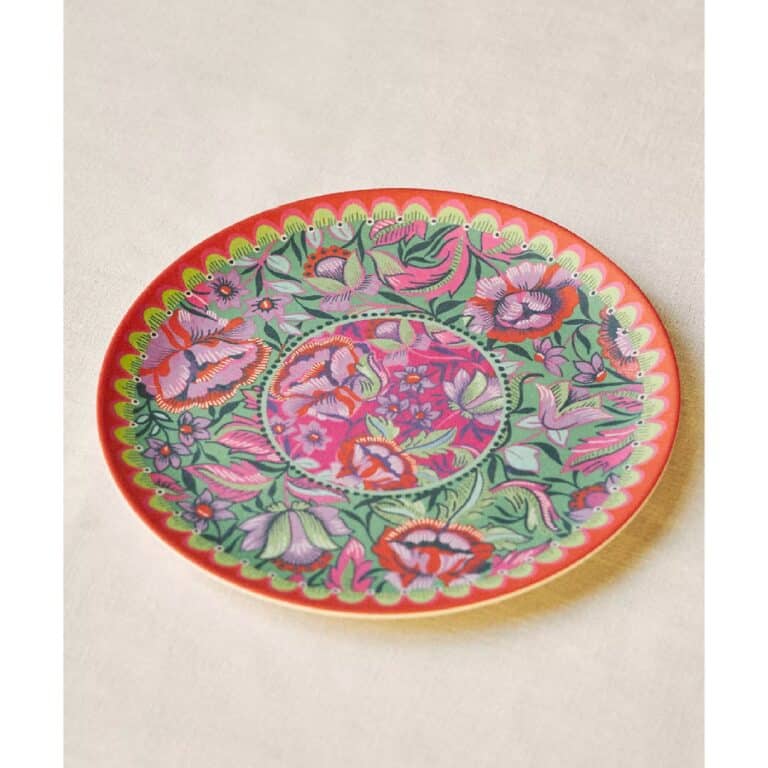 Patterned plate with red, green, and purple flowers